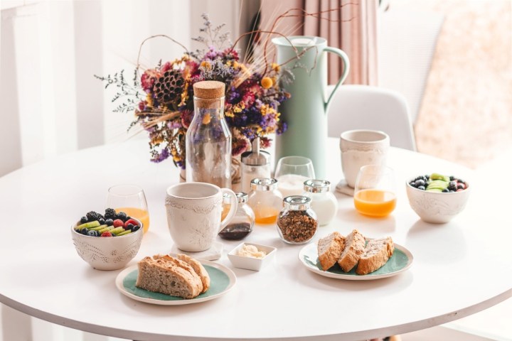 A table nicely decorated with breakfast dishes.