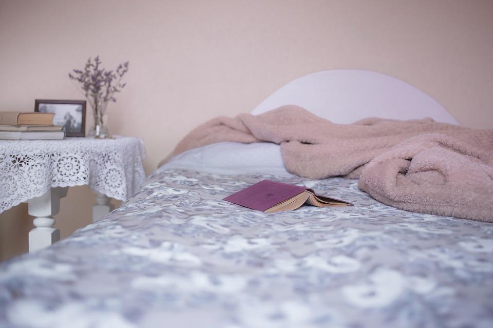 bed with a fluffy pink blanket on it
