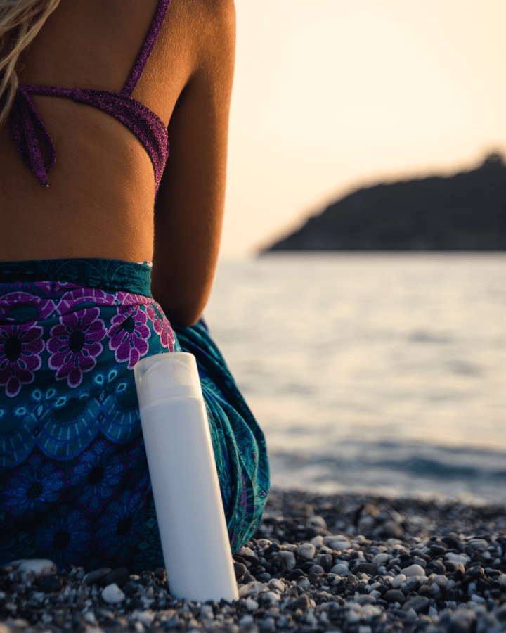 woman on beach with sunscreen